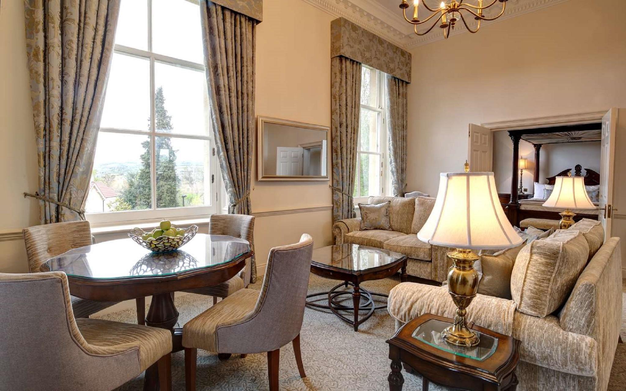 Macdonald Bath Spa Hotel Екстер'єр фото The photo displays a beautifully furnished living room. The room features large windows dressed with elegant curtains that allow natural light to flood in. There is a comfortable seating area with a stylish sofa and chairs arranged around a small cof