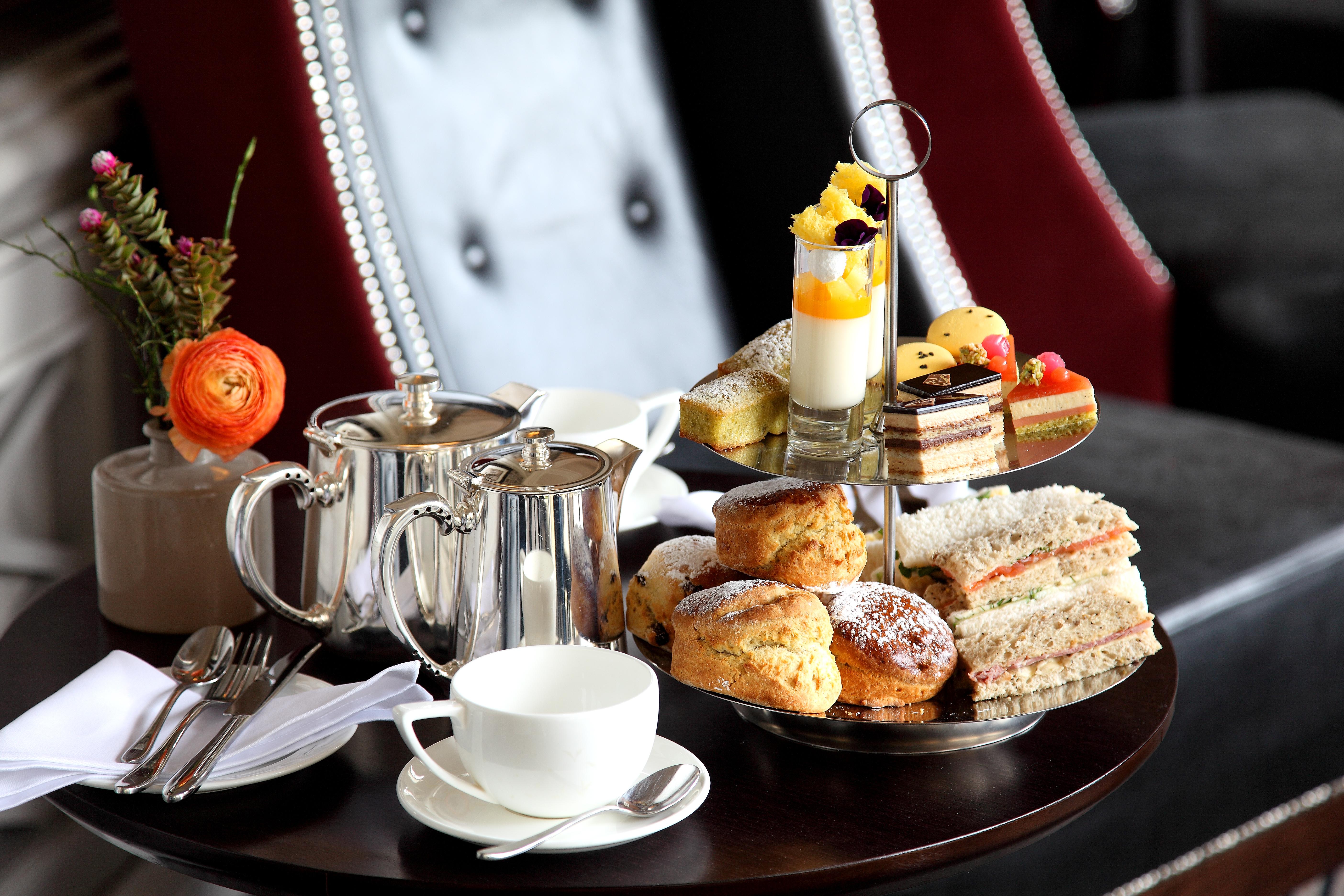 Macdonald Bath Spa Hotel Екстер'єр фото The photo depicts an elegantly arranged afternoon tea setting. There is a tiered stand filled with a variety of treats, including scones, sandwiches, and small desserts like cakes and pastries. Accompanying this is a teapot and a cup on the table, su