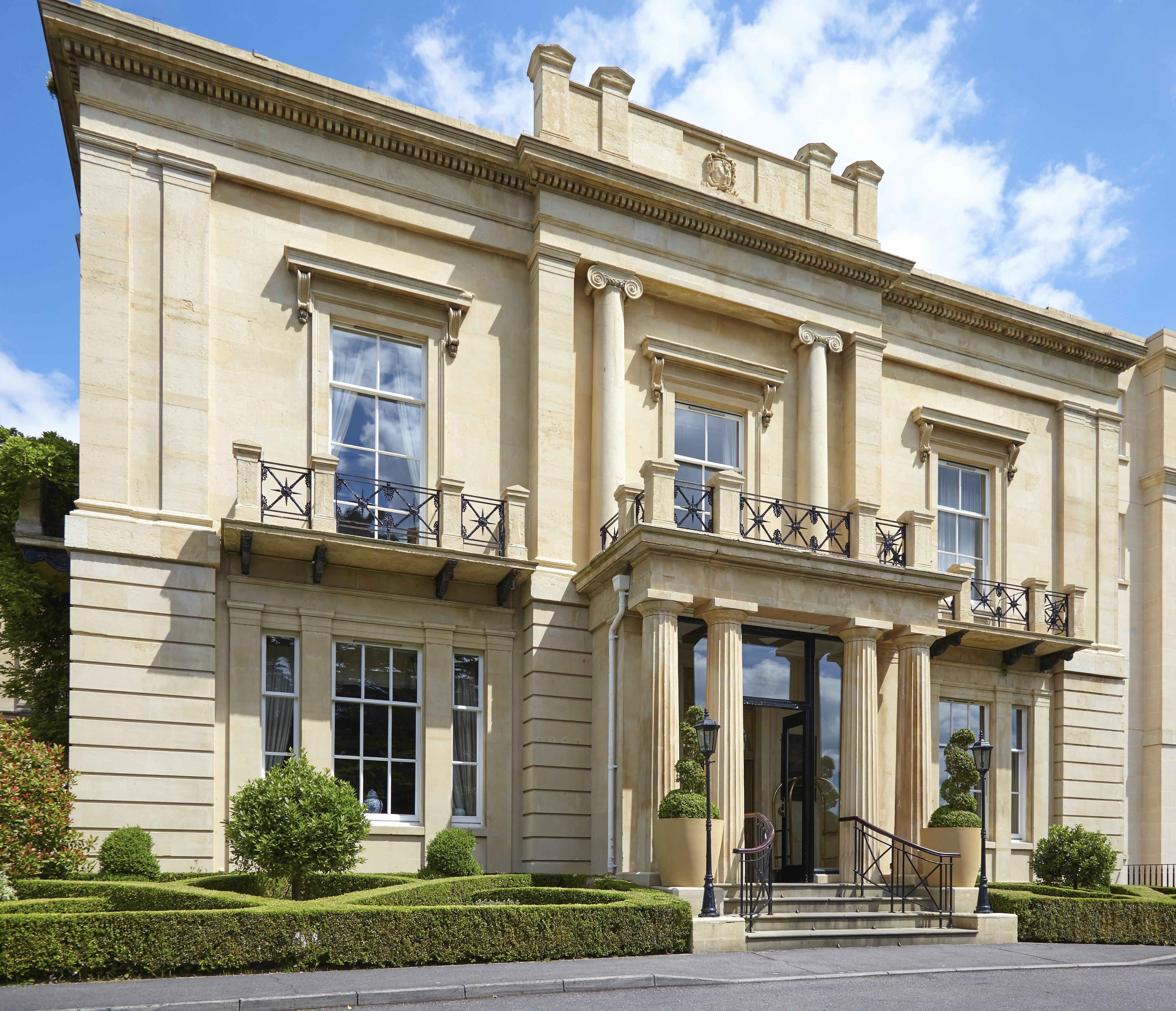 Macdonald Bath Spa Hotel Екстер'єр фото The photo shows a large, elegant building designed in a classical architectural style. It features a symmetrical facade with tall columns and decorative details. The entrance is marked by a set of stairs leading up to double doors, flanked by windows